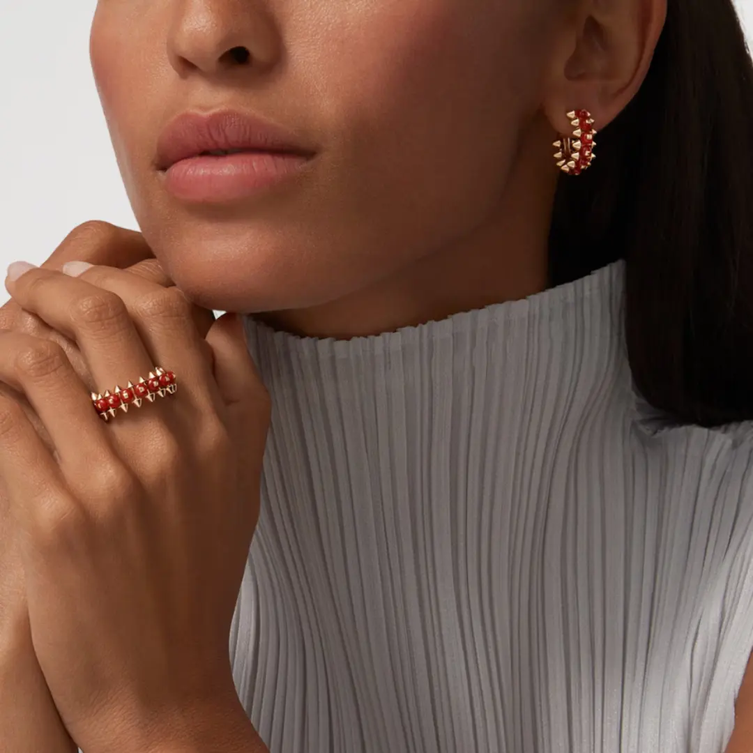 18K Gold Clash de Cartier Agate Earrings copy Model wearing 18K Gold Clash de Cartier Agate Earrings fake with red agate for daily wear and stacked ear styling.