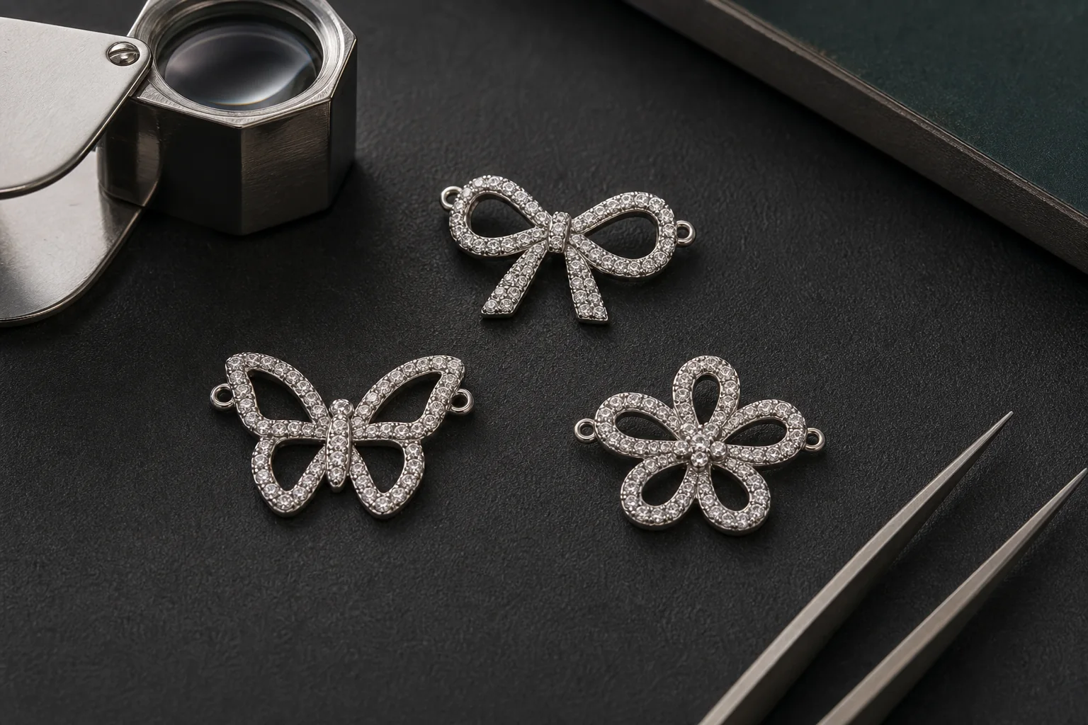 Conceptual bow, butterfly and flower pavé jewelry motifs under workshop inspection